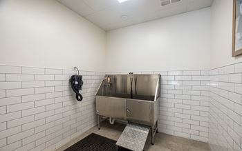a public restroom with a stainless steel sink and a telephone